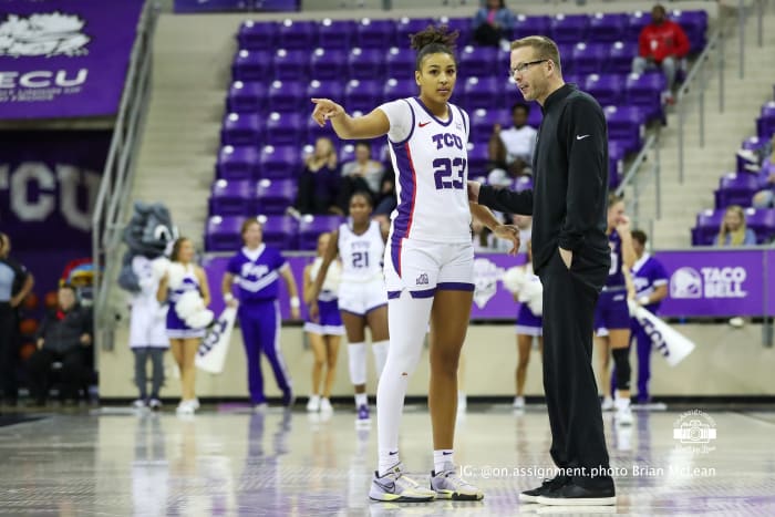 Aaliyah Roberson (23) and coach Mark Campbell discuss on-court action during a game against ACU.